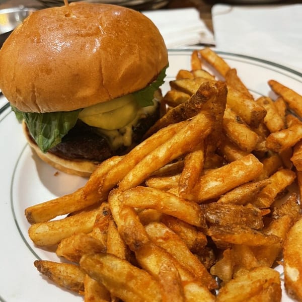 A Grille No. 13 burger with lettuce, cheese, and a side of crispy french fries.