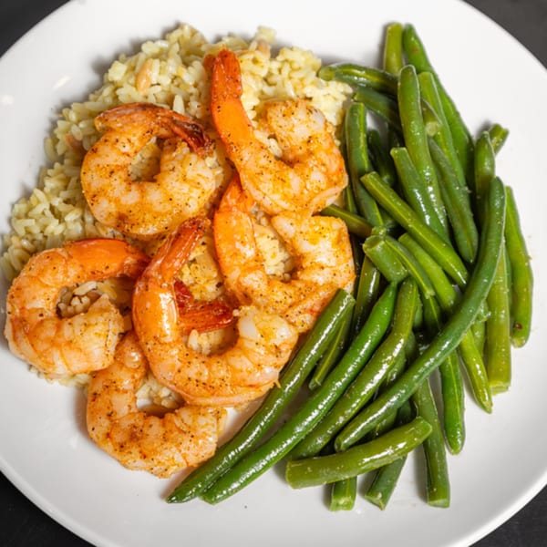 Grille No. 13's shrimp and rice with green beans on a white plate.