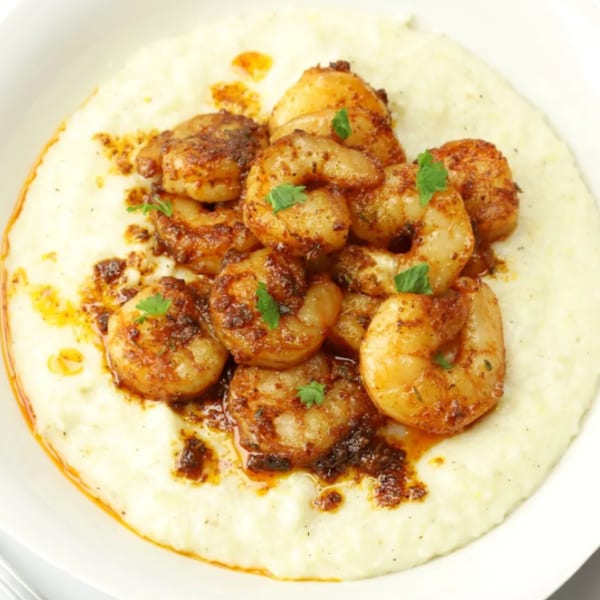 Grille No. 13's American-style shrimp and grits, featuring seasoned shrimp on creamy white grits.